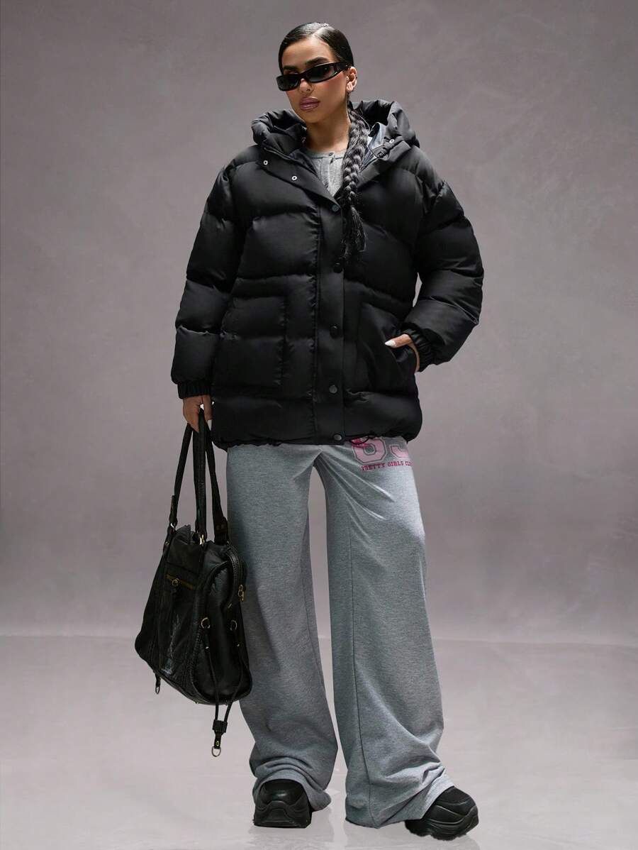Oversize vinterjakke dame i pufferstil med hætte, store lommer og trykknapper, Sort, billede 4